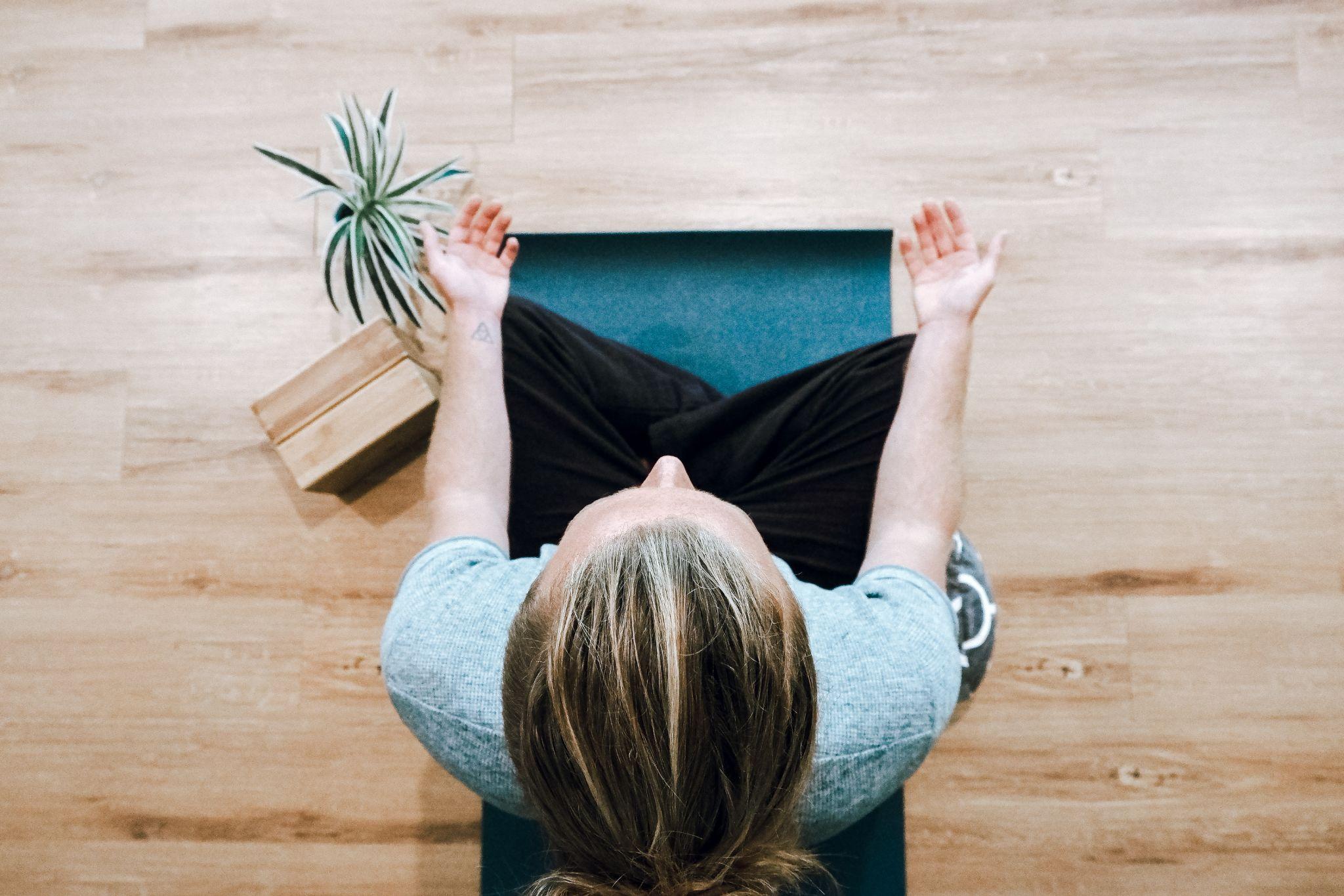 woman doing yoga meditation at home